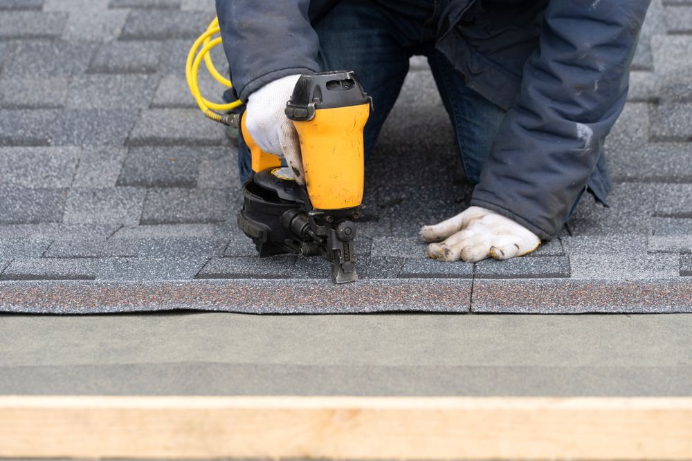 nailing shingles to a roof