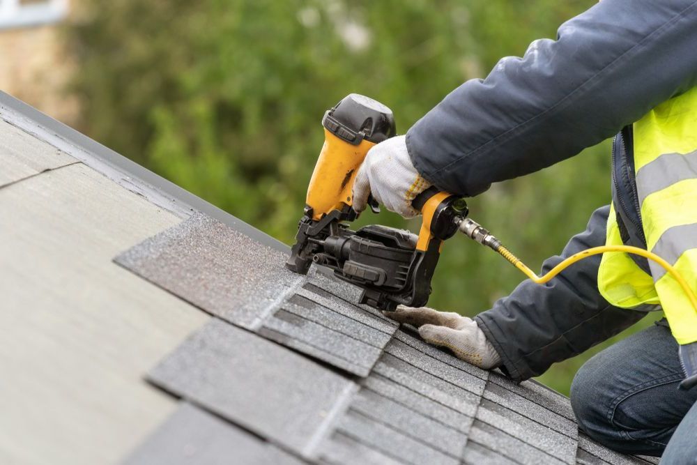 nailing shingles to a roof