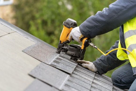 nailing shingles to a roof