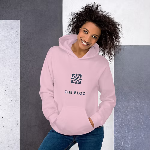 A woman is wearing a red hoodie and smiling.