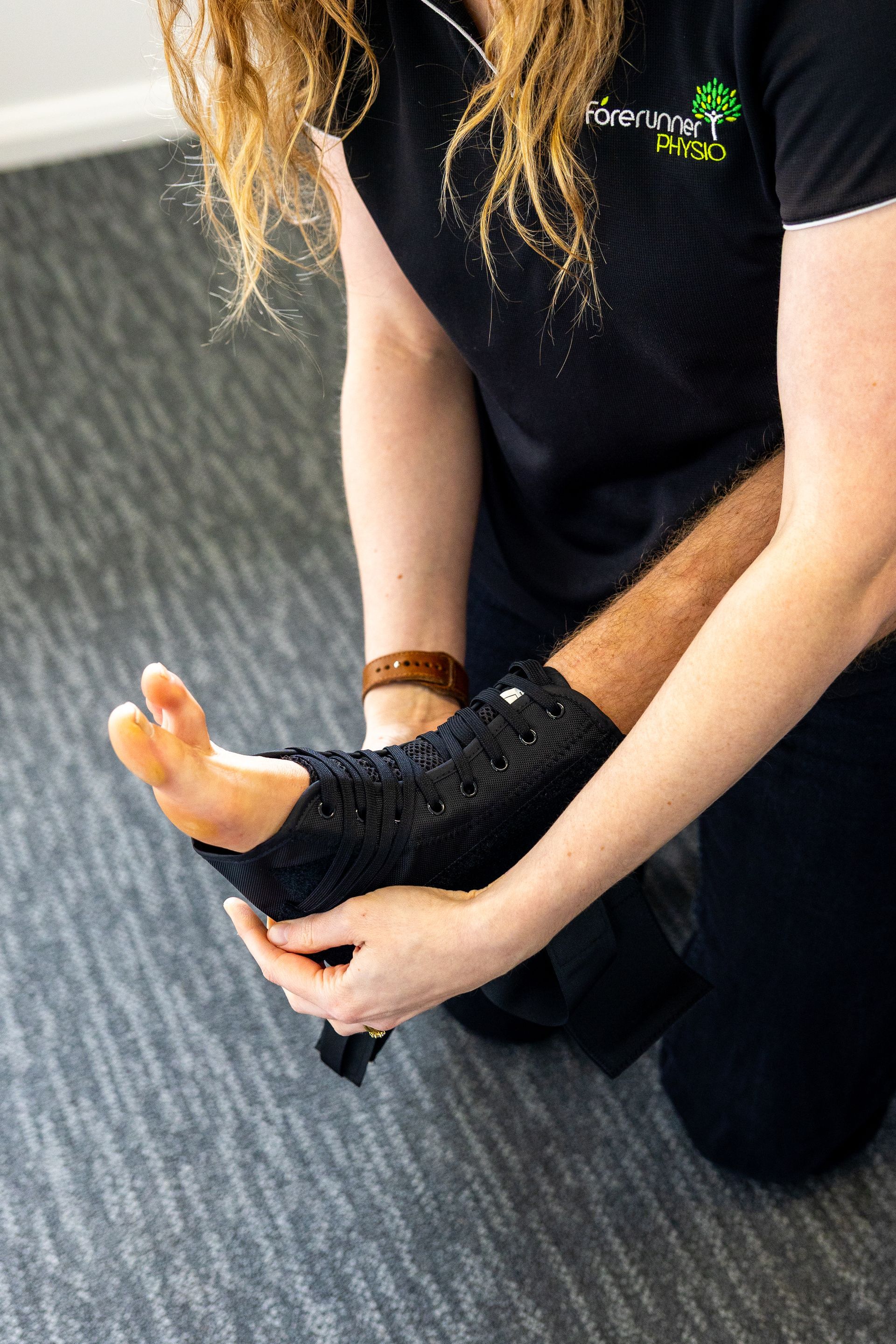 A Healthcare Provider Examining a Patient's Lower Back — Forerunner Physio In Taree, NSW