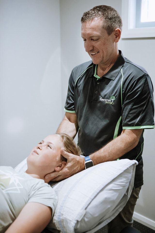Therapist Gently Adjusting a Patient's Head — Forerunner Physio In Taree, NSW