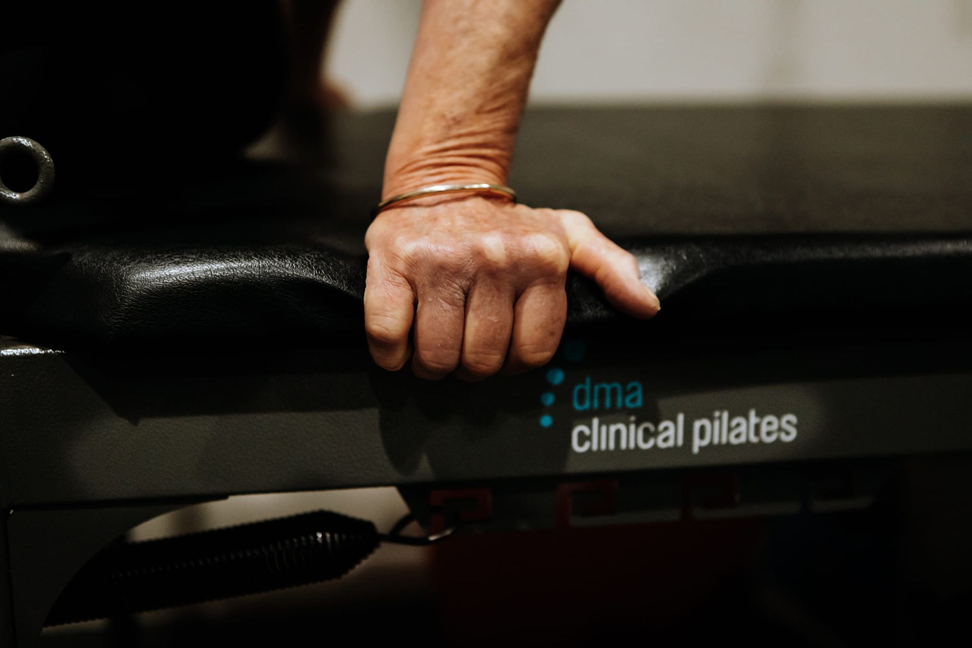 Hand Holding a Pilates Machine Handle — Forerunner Physio In Taree, NSW