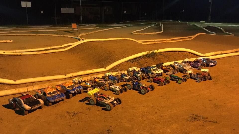 Toy Model Car In Front Of Stacked Boxes With Car Images On A Carpeted Surface — Midtown Hobbies In Lismore, NSW