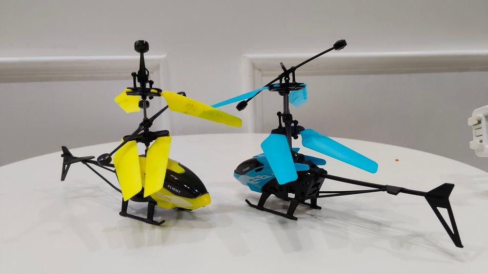 Two Toy Helicopters, Yellow And Blue, On A White Surface — Midtown Hobbies In Lismore, NSW