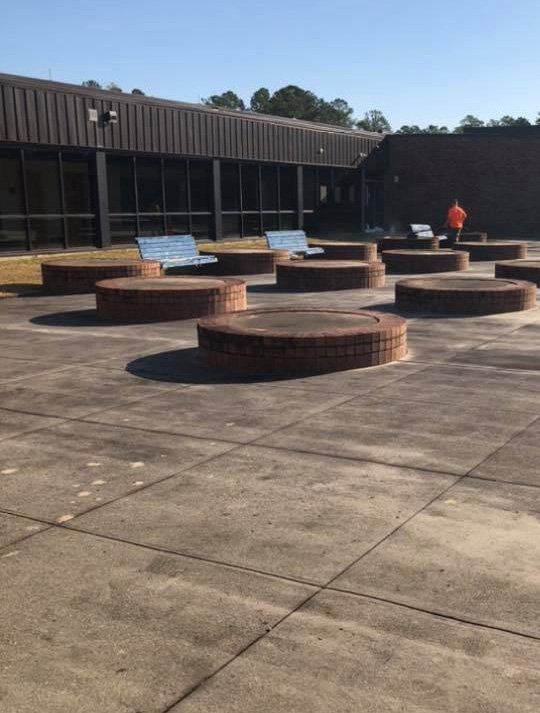 A row of brick benches in front of a building