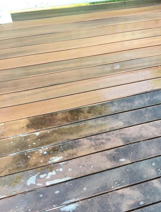 A close up of a wooden deck with stains on it.
