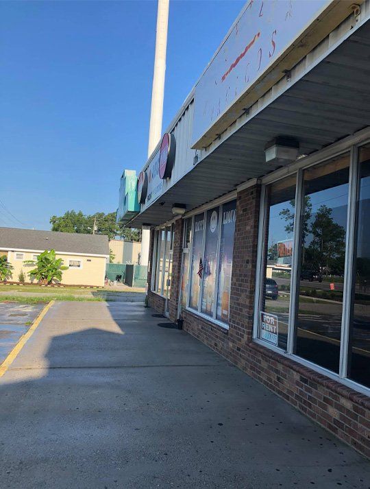 A building with a lot of windows and a sign that says no parking