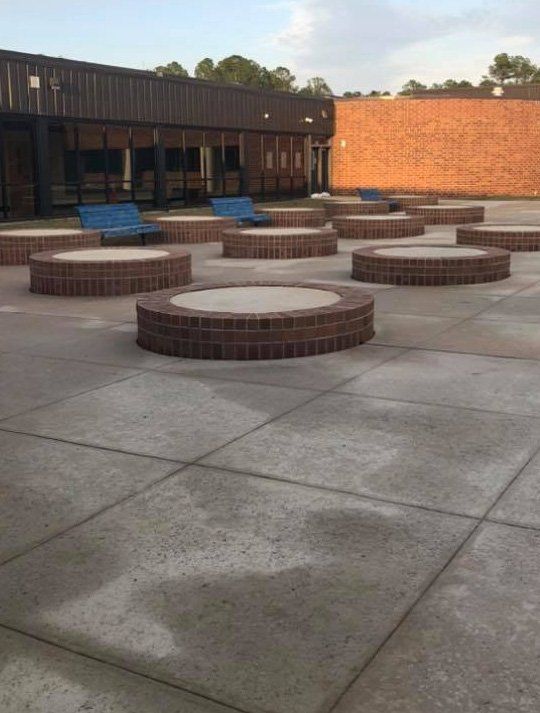 A brick building with a lot of circles in front of it