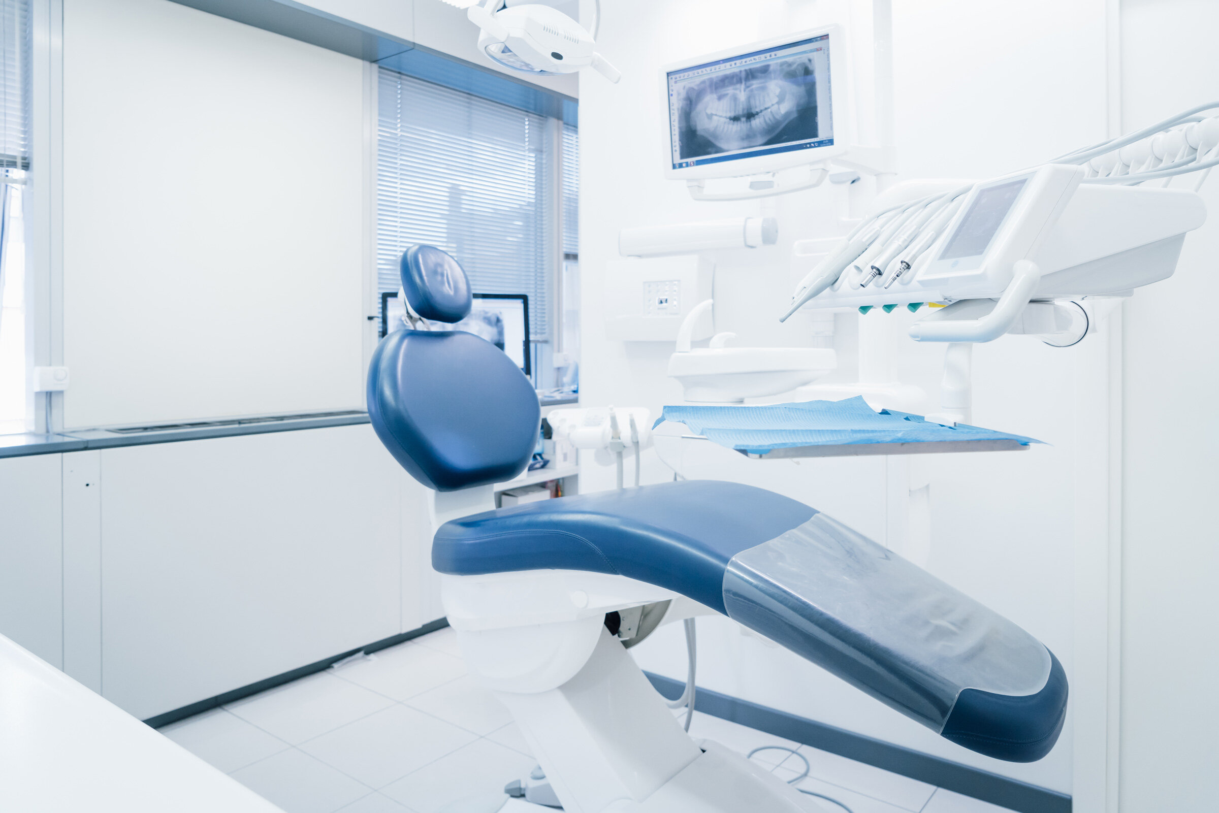 Dental Assistant adjusting settings on dental equipment