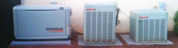A standby generator and two air conditioning units are on concrete pads outdoors. A standby generator and two air conditioning units are on concrete pads outdoors.