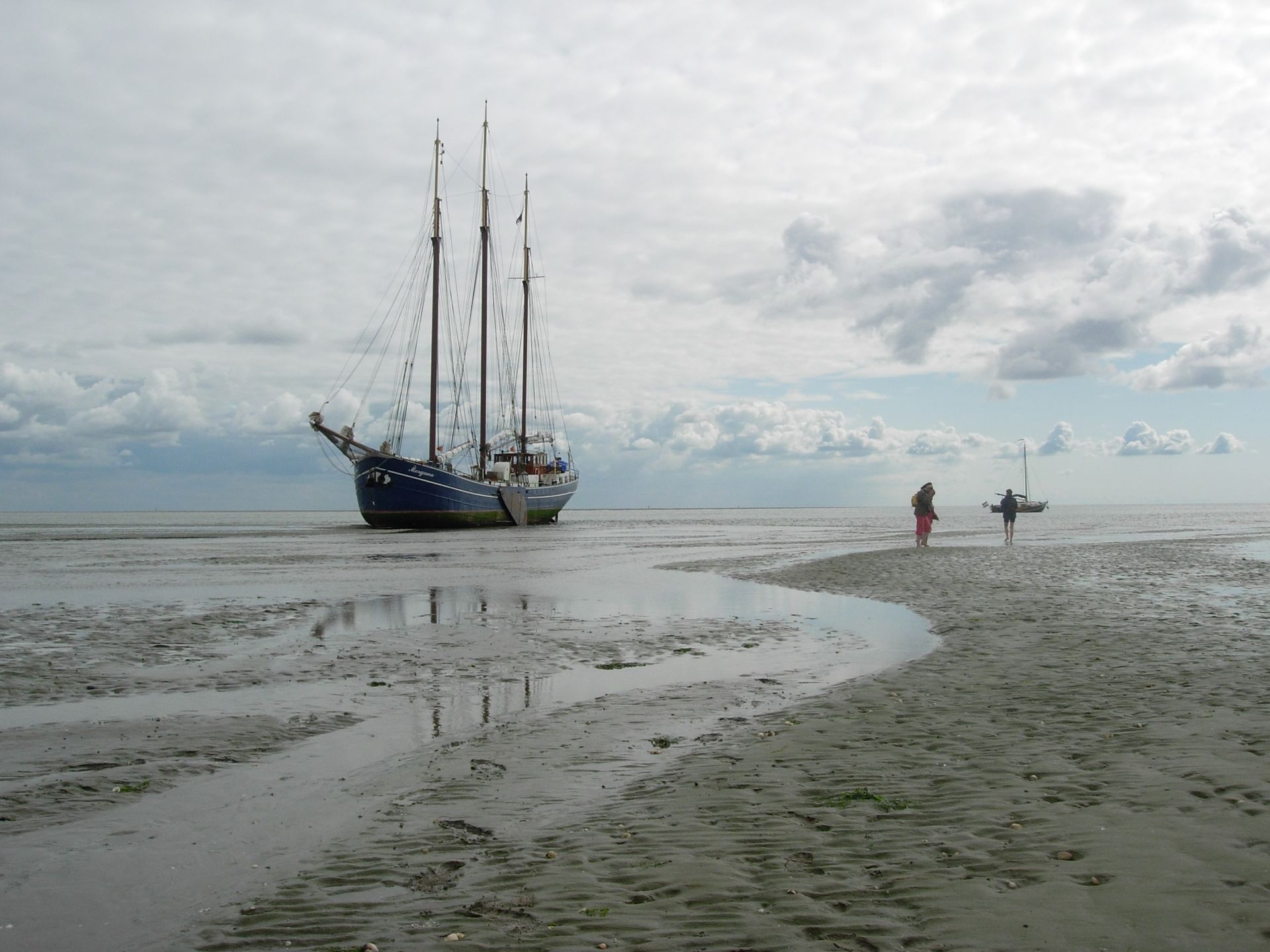 Tall ship Morgana dried out near Boschplaat (Terschelling) on the Dutch Wadden Sea, with a wide view across sand and sea.