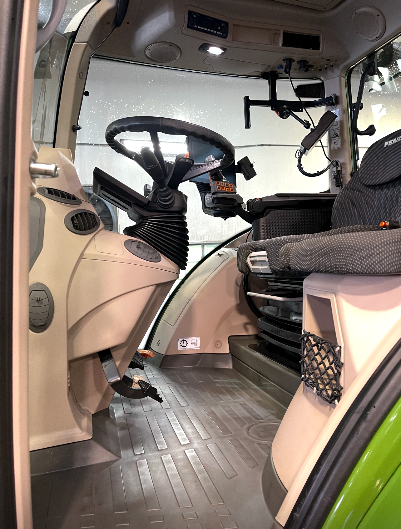 the inside of a tractor with a wooden floor and a steering wheel .