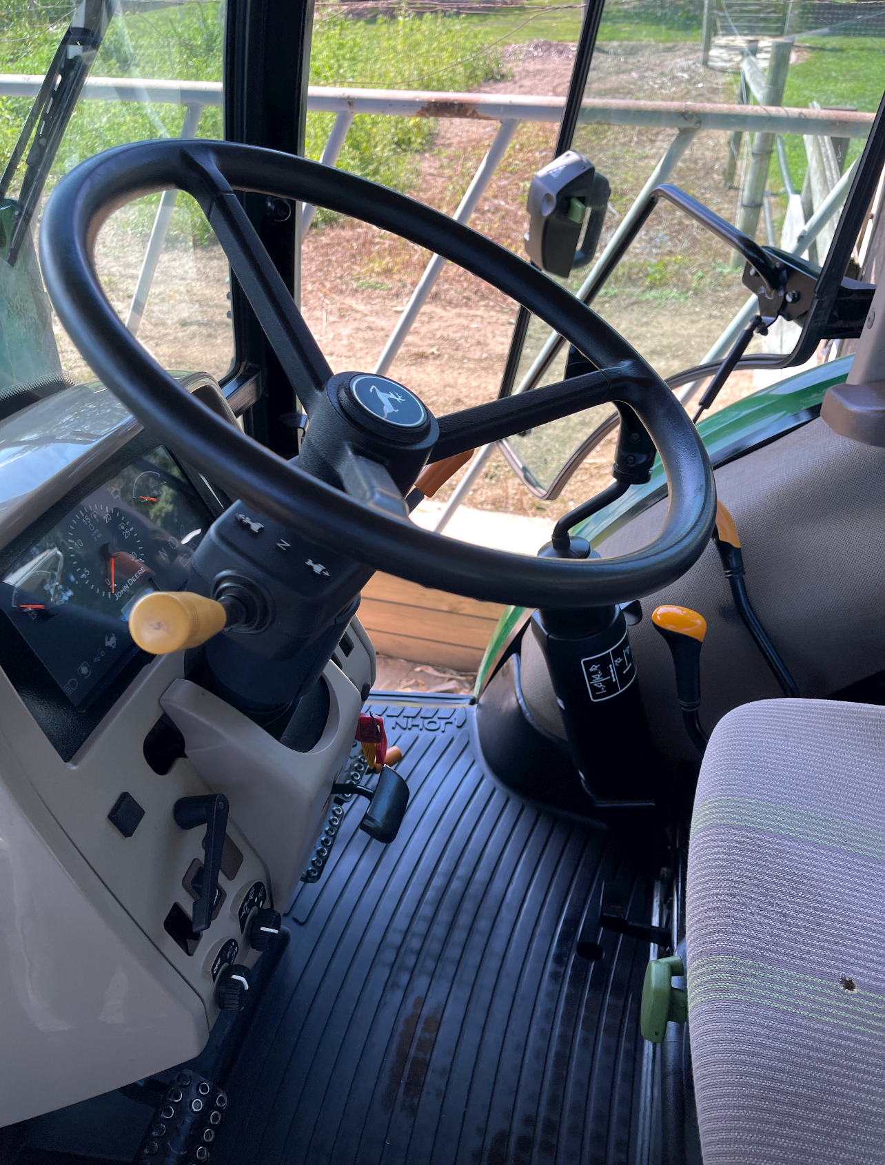 the inside of a tractor with a steering wheel and dashboard