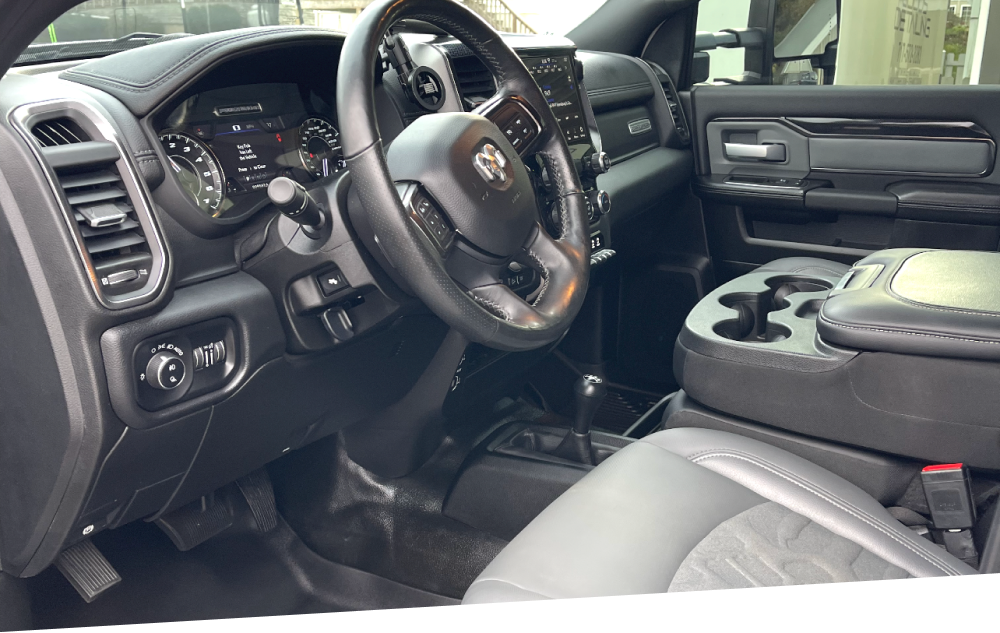 the interior of a dodge ram truck with a steering wheel and dashboard .
