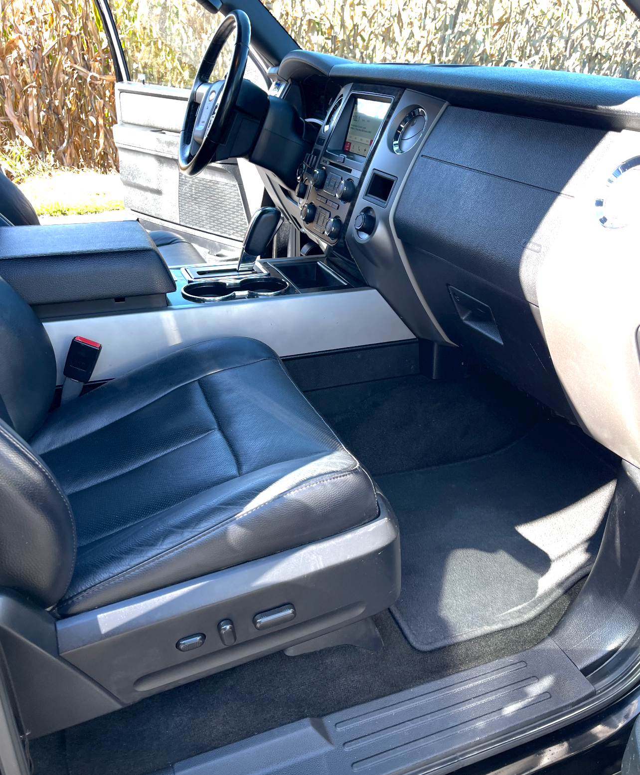 the interior of a car with black seats and a steering wheel .