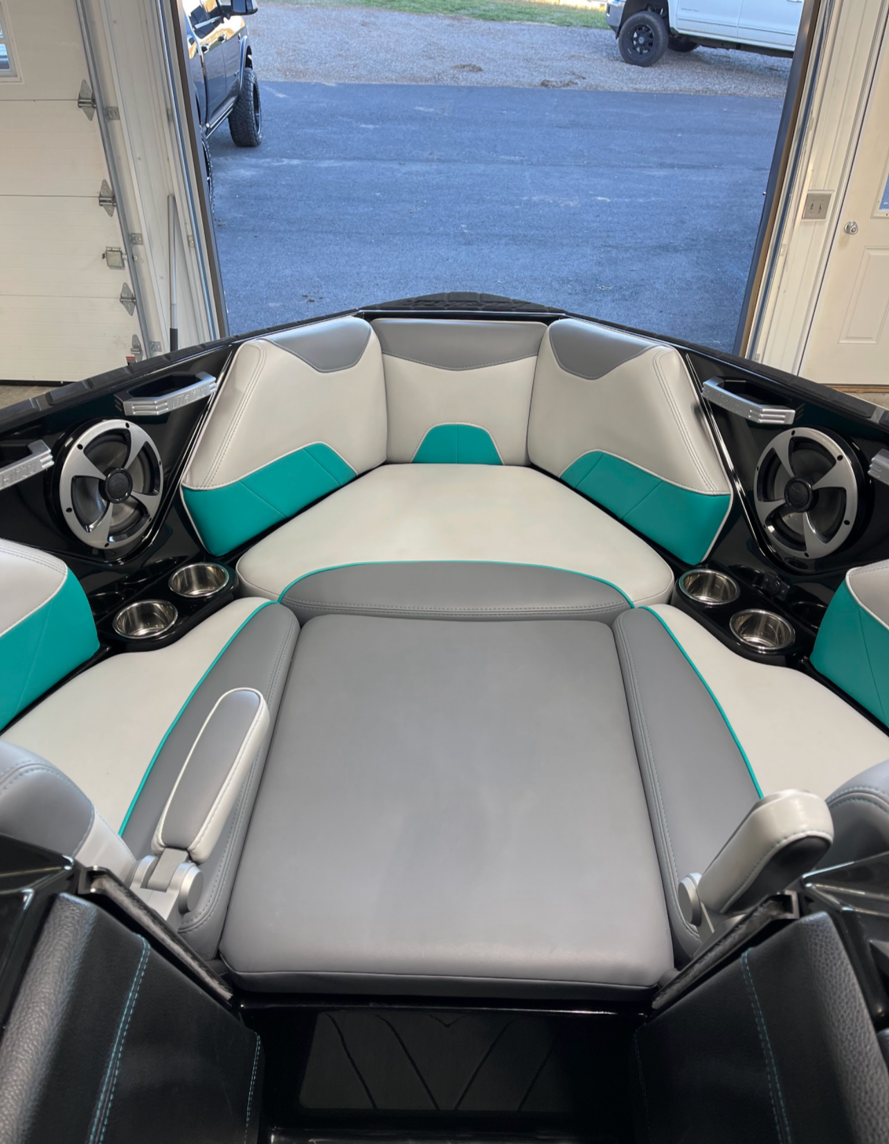 the inside of a boat with a bed and speakers .