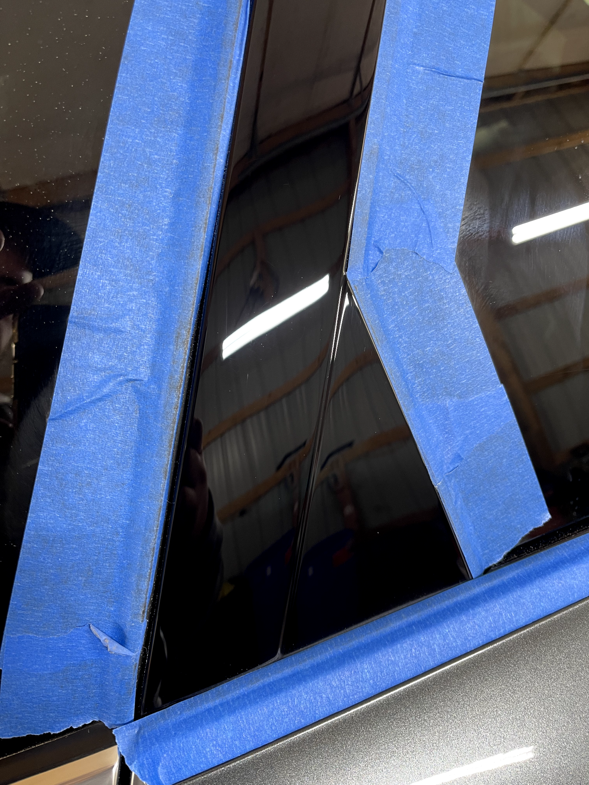 a close up of a car with blue tape on it