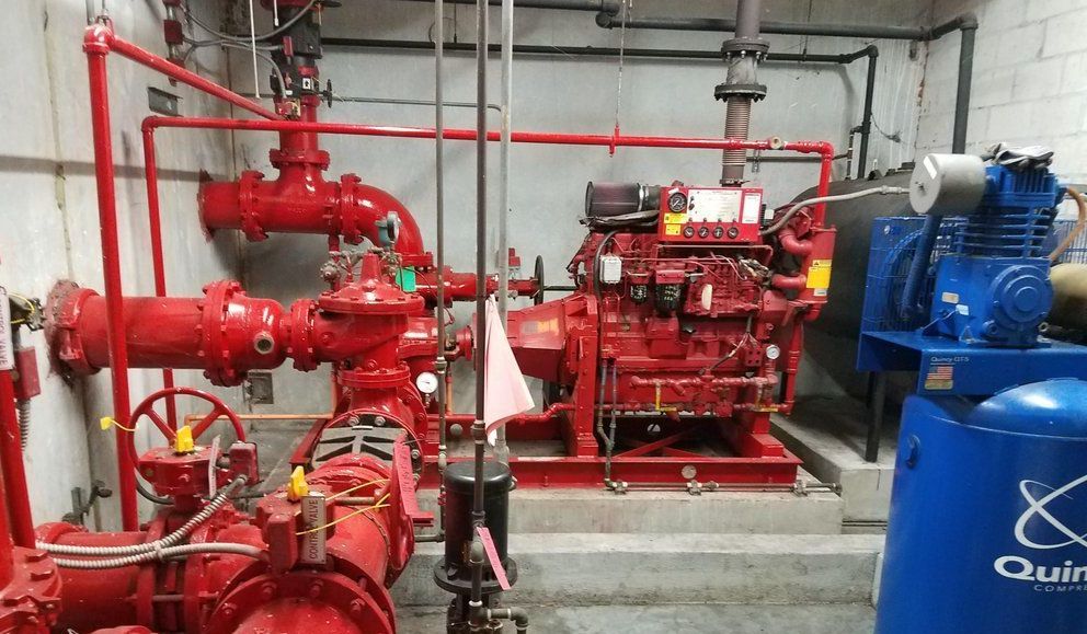 A room filled with lots of red pipes and pumps.