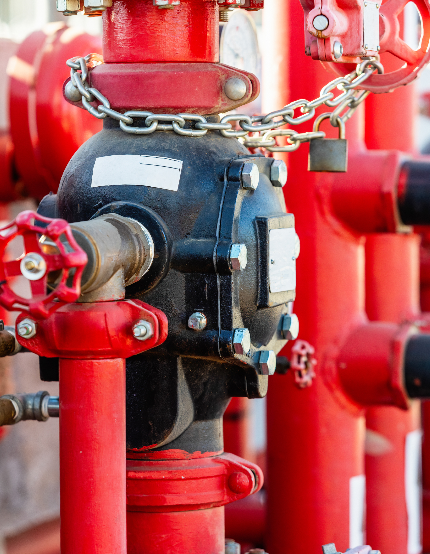 A close up of a fire hydrant with a chain around it.