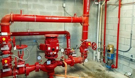 A room filled with lots of red pipes and valves.