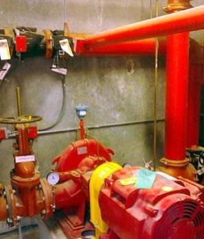 A room with a lot of red pipes and pumps
