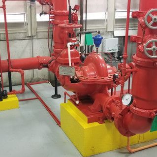 A room filled with lots of red pipes and pumps.