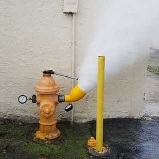 A fire hydrant with smoke coming out of it.