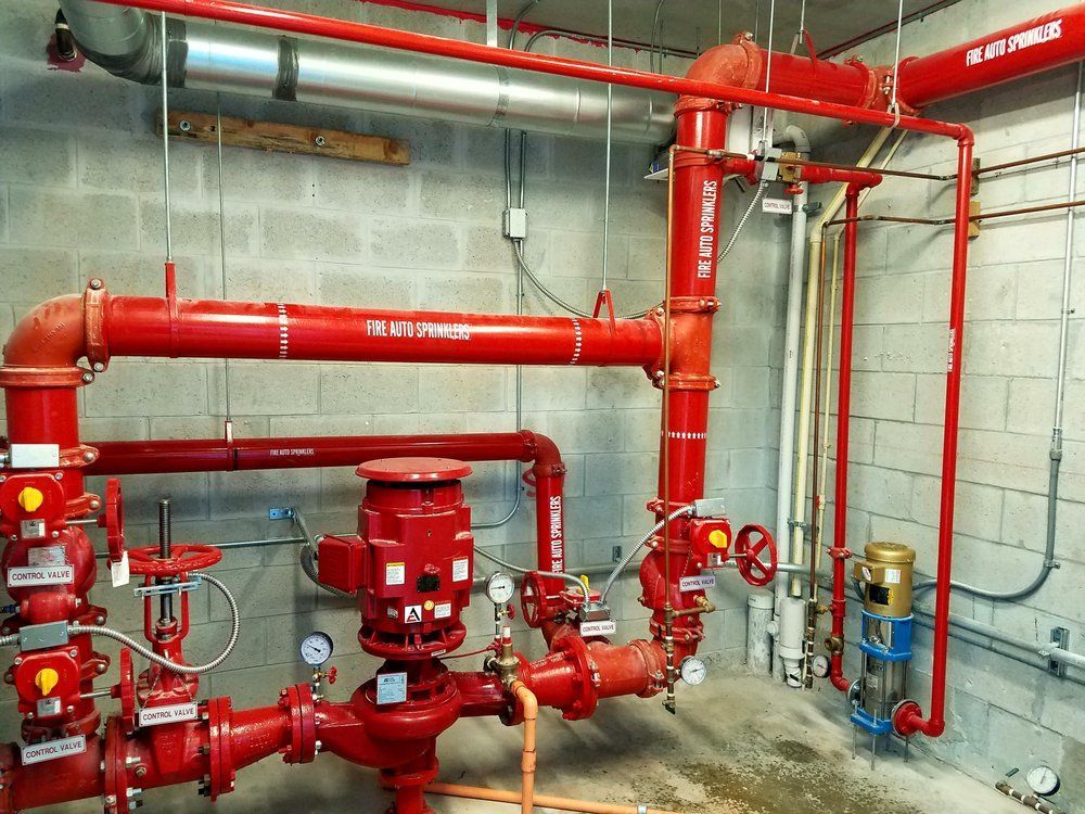 A room with a lot of red pipes and valves