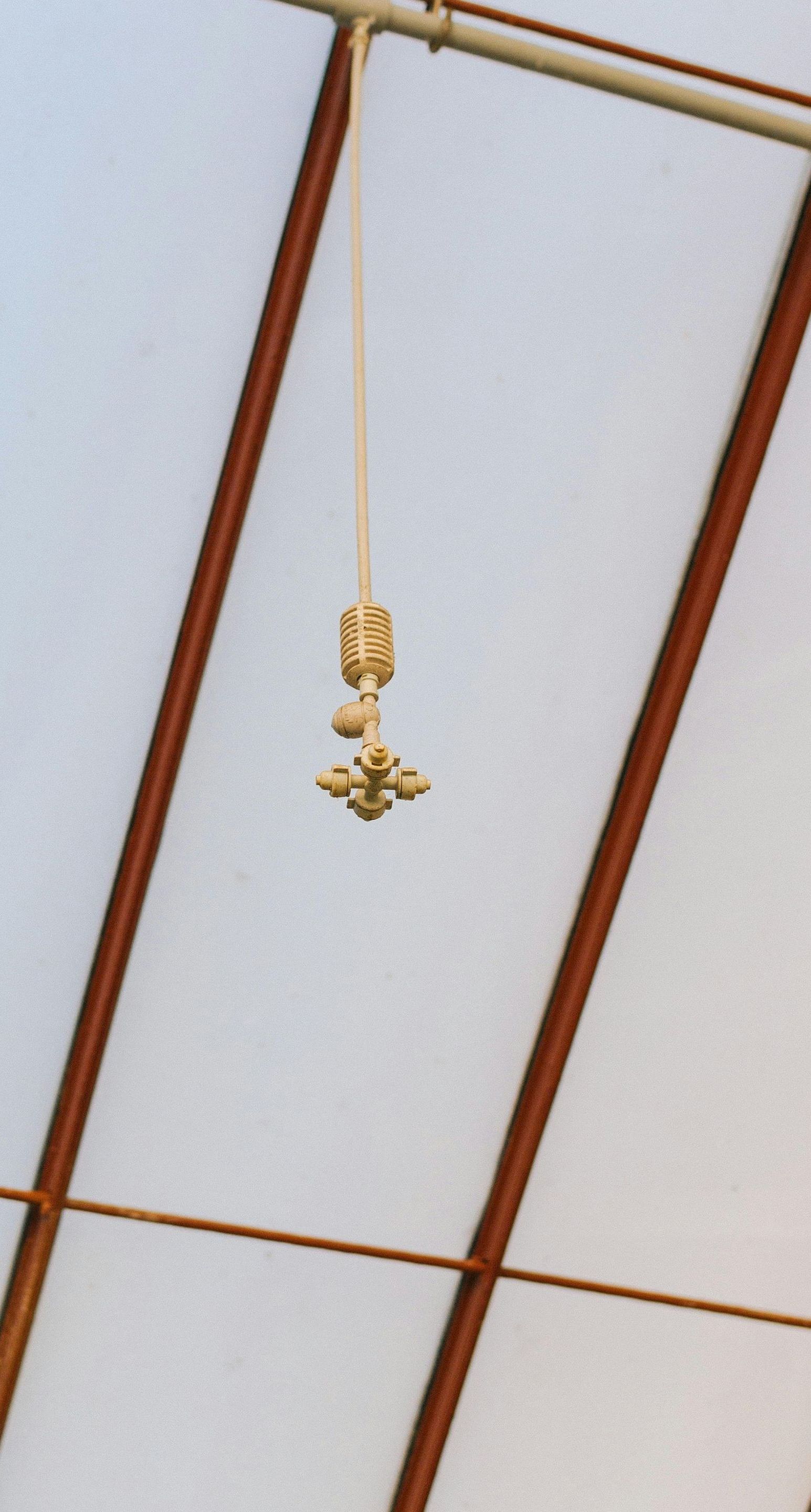 A cross is hanging from the ceiling of a building
