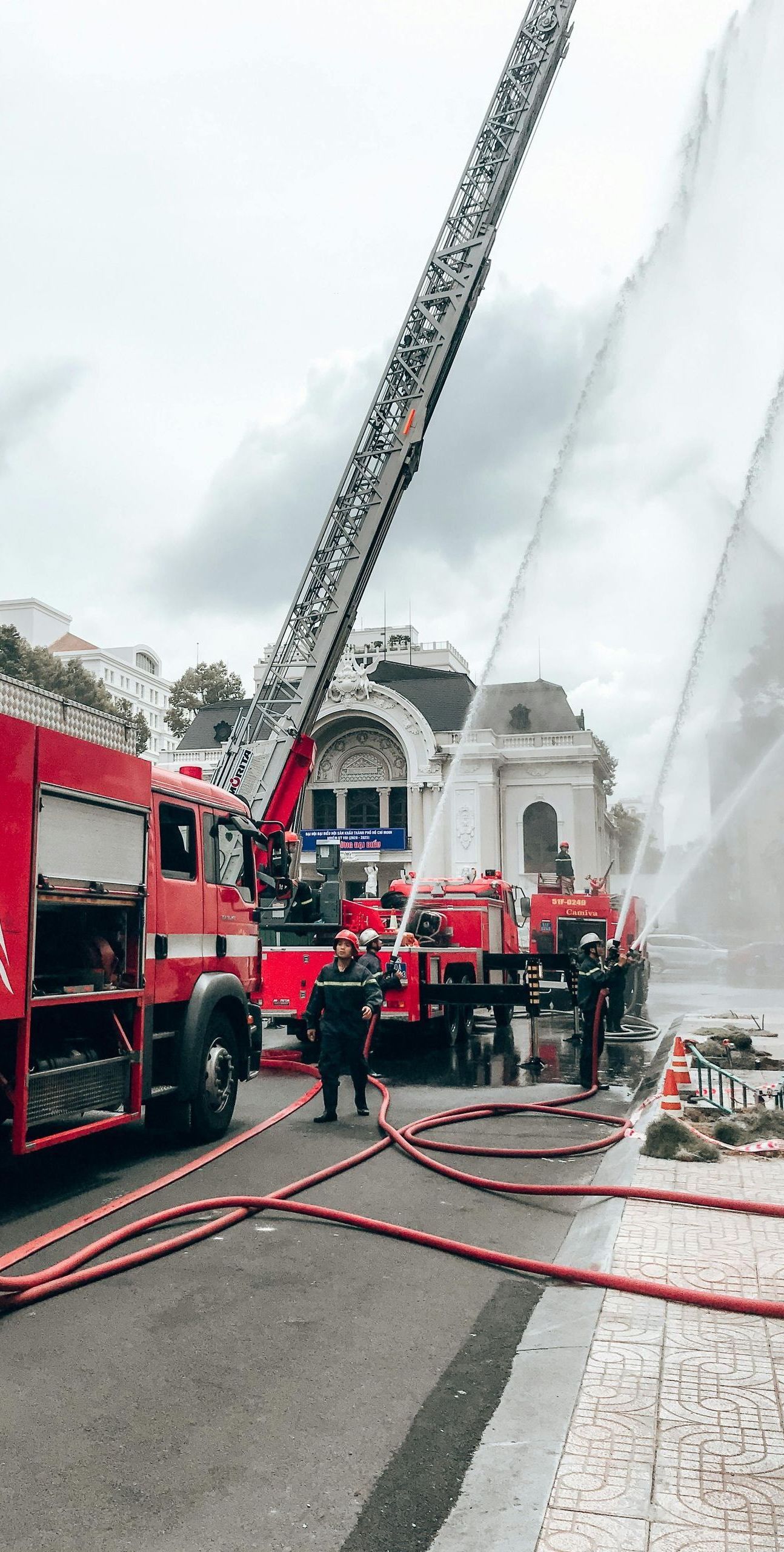A fire truck is spraying water on a building.