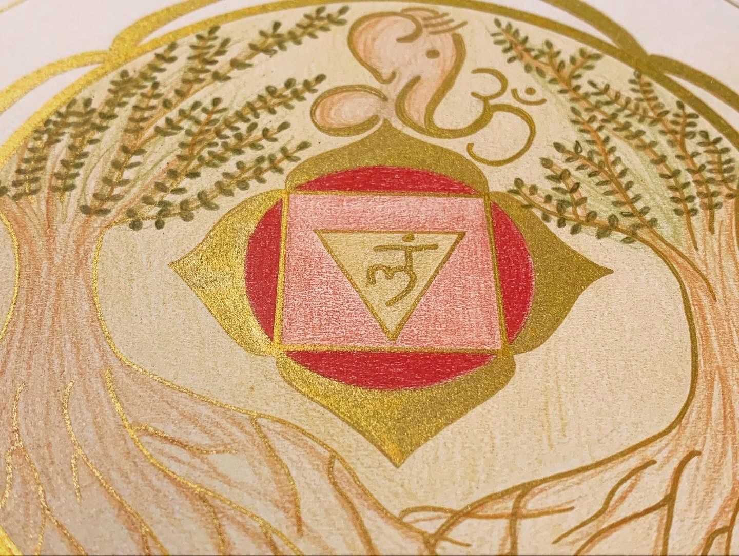 Artwork of a red and gold chakra symbol with a pink triangle, beneath a Ganesha figure and Om symbol.