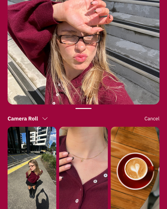 Person taking a selfie outdoors in burgundy top and glasses, with photos shown in a phone gallery below