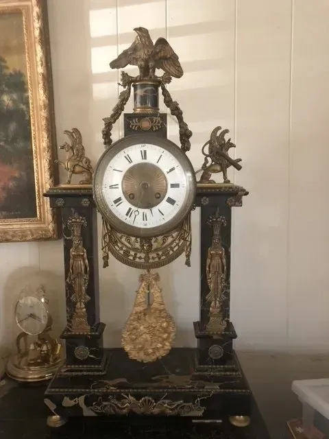 vintage clock with bird at top
