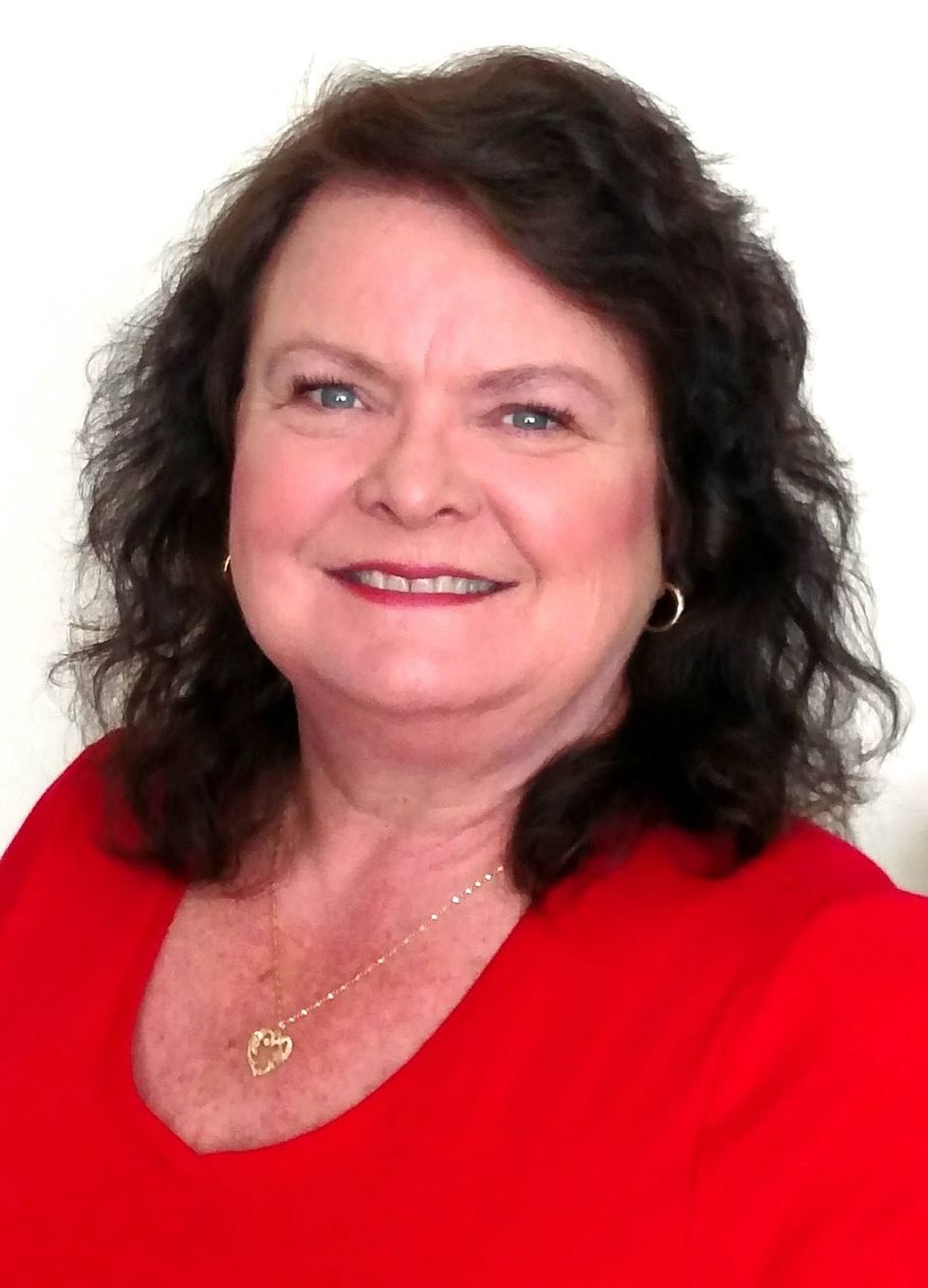 Portrait of a smiling woman in a red top against a white background