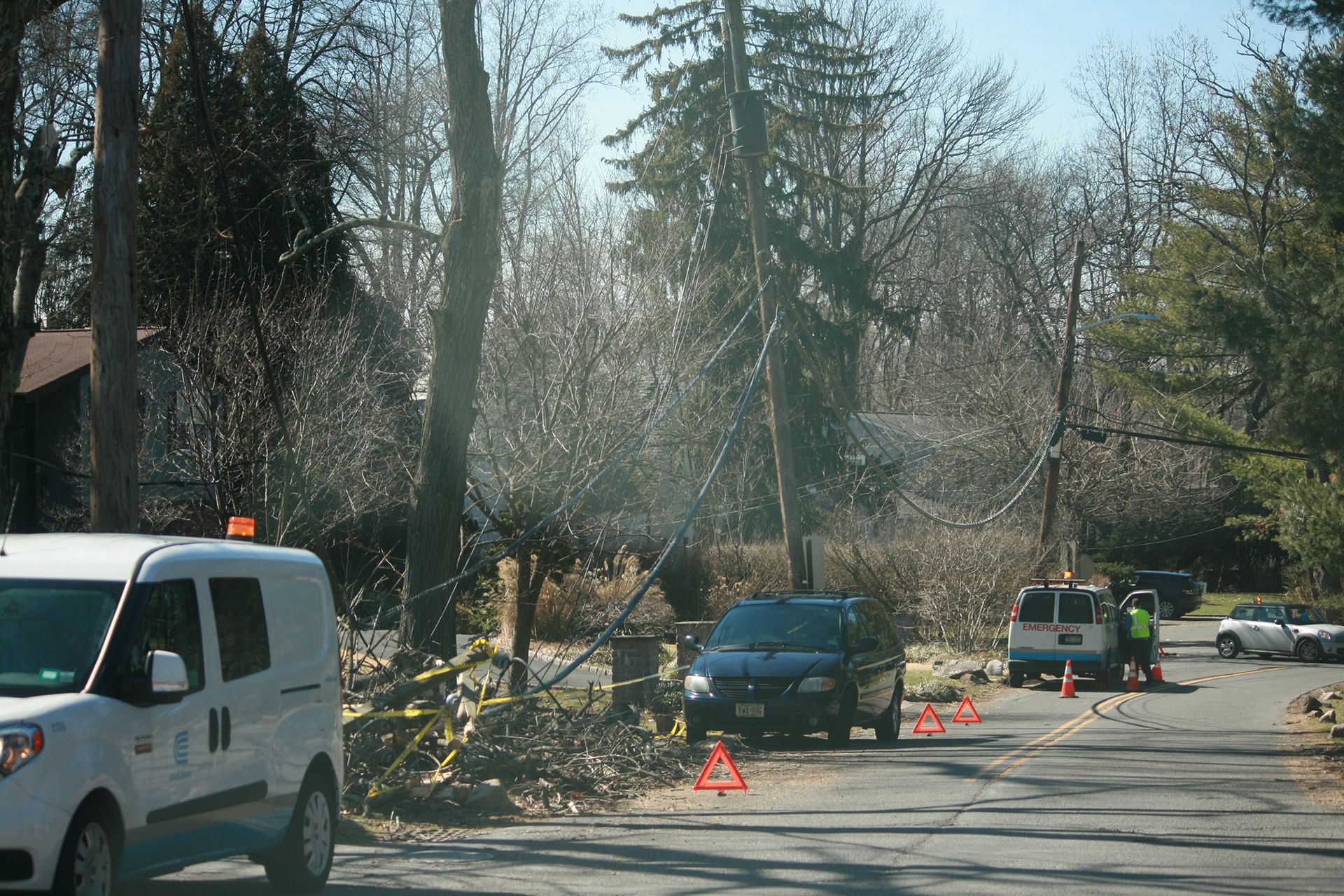 A white van is parked on the side of the road