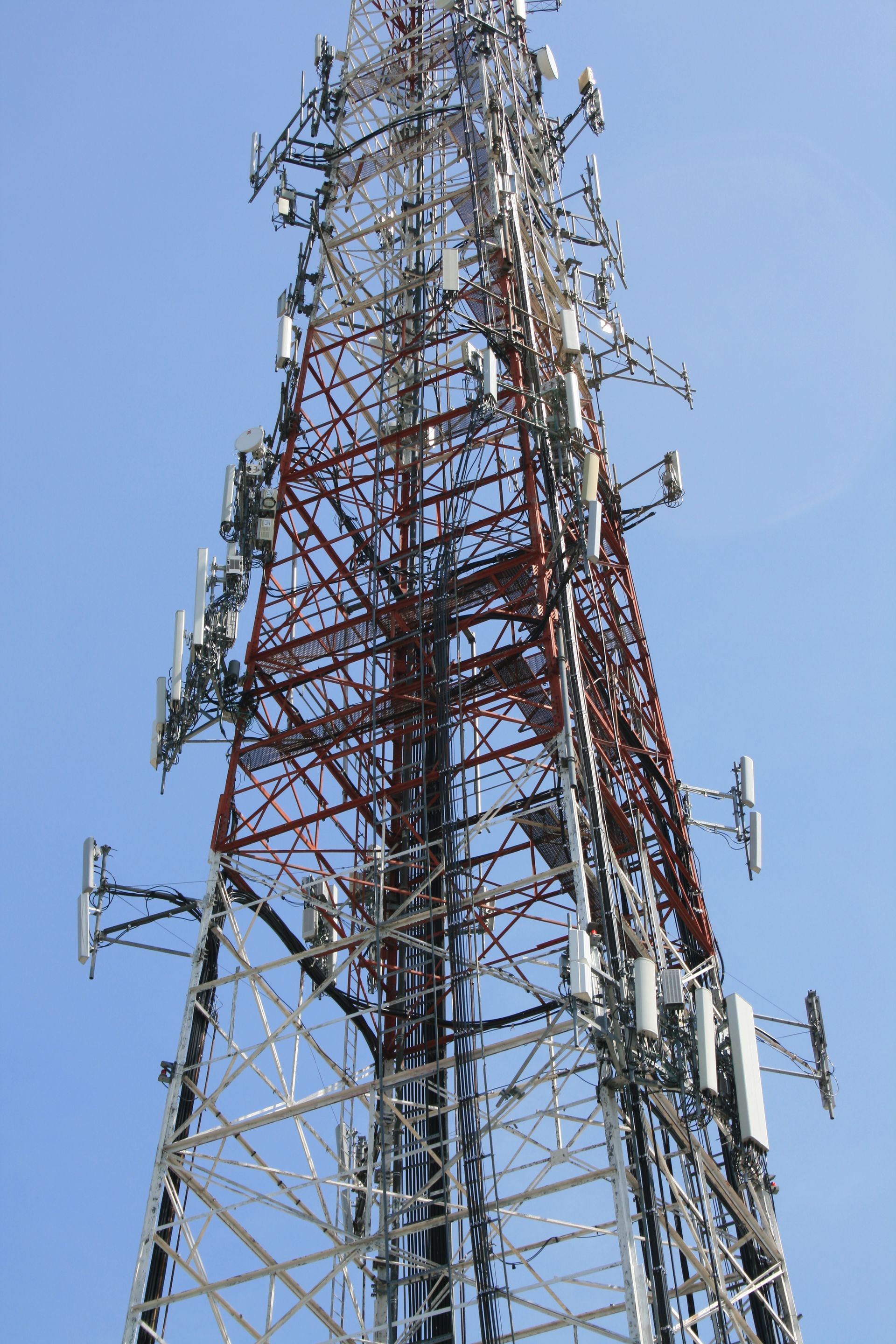 A very tall tower with a lot of antennas on it