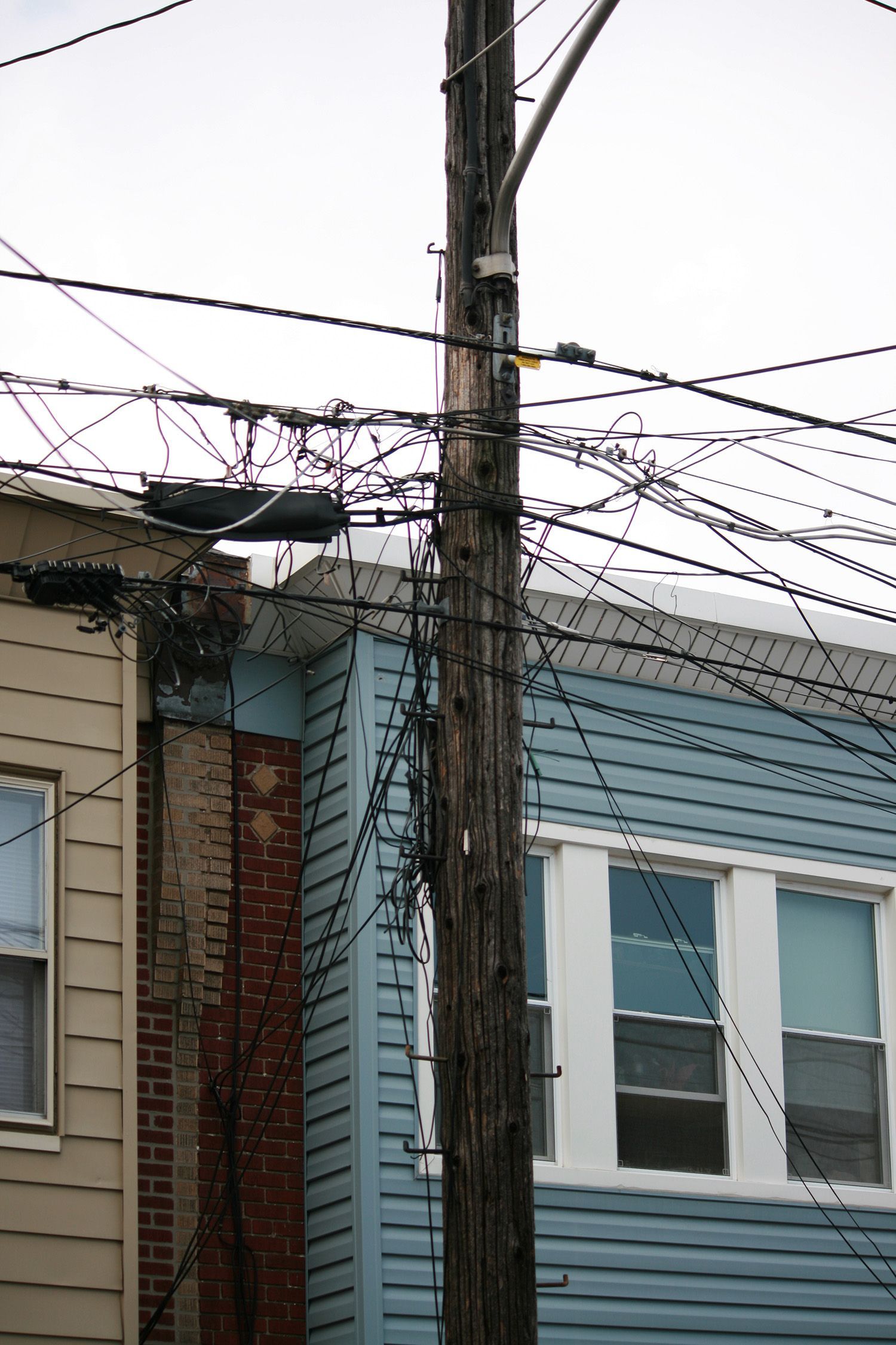 A telephone pole with barbed wire attached to it