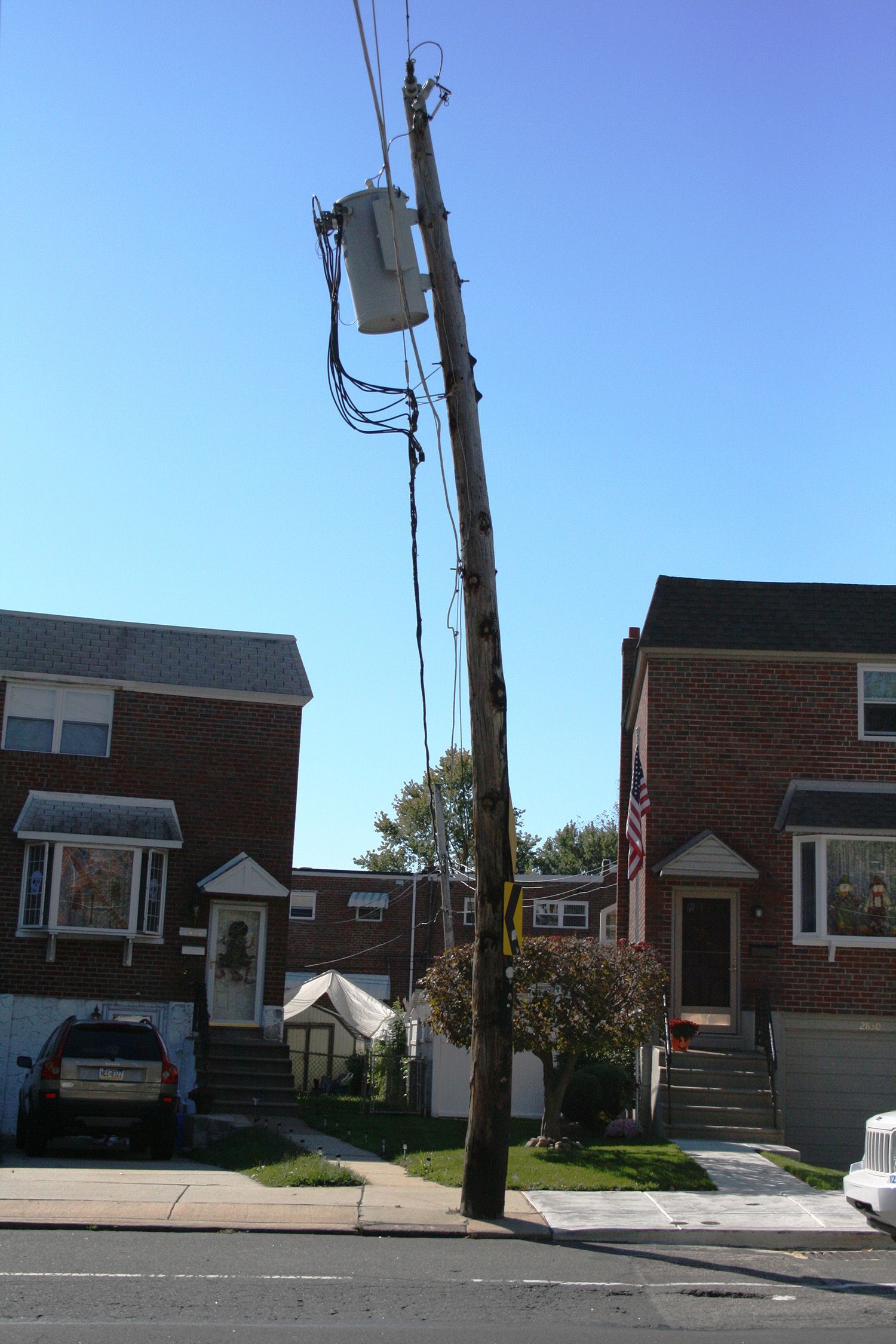 A telephone pole with a bucket attached to it