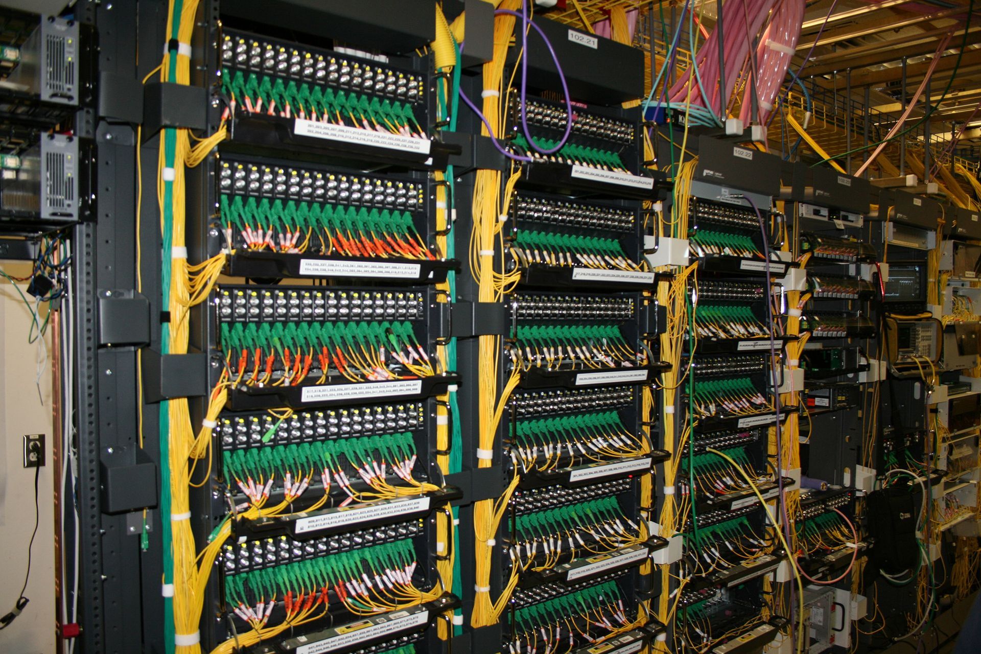 A row of servers with lots of wires coming out of them