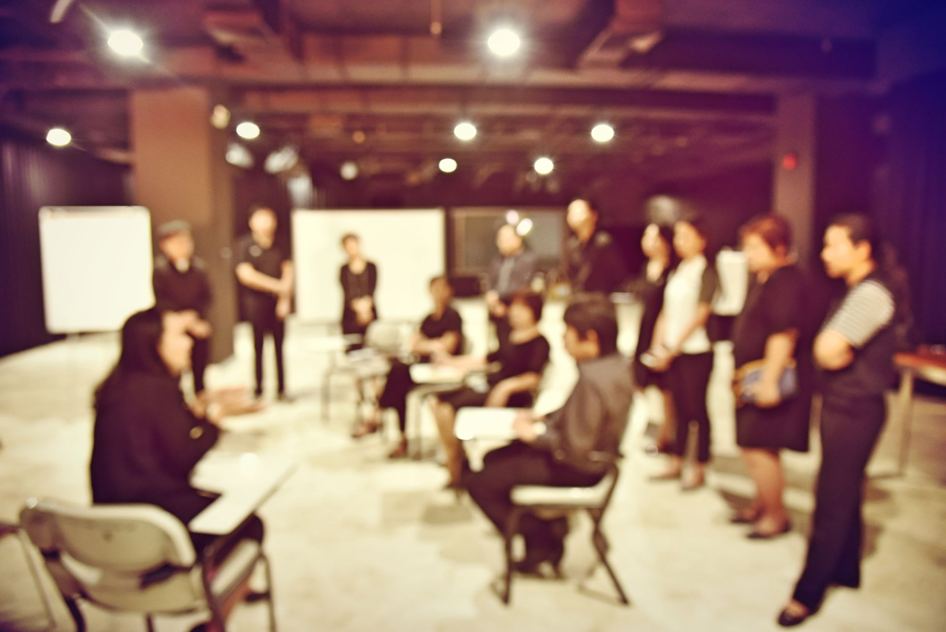 A group of people are sitting in a circle in a room.