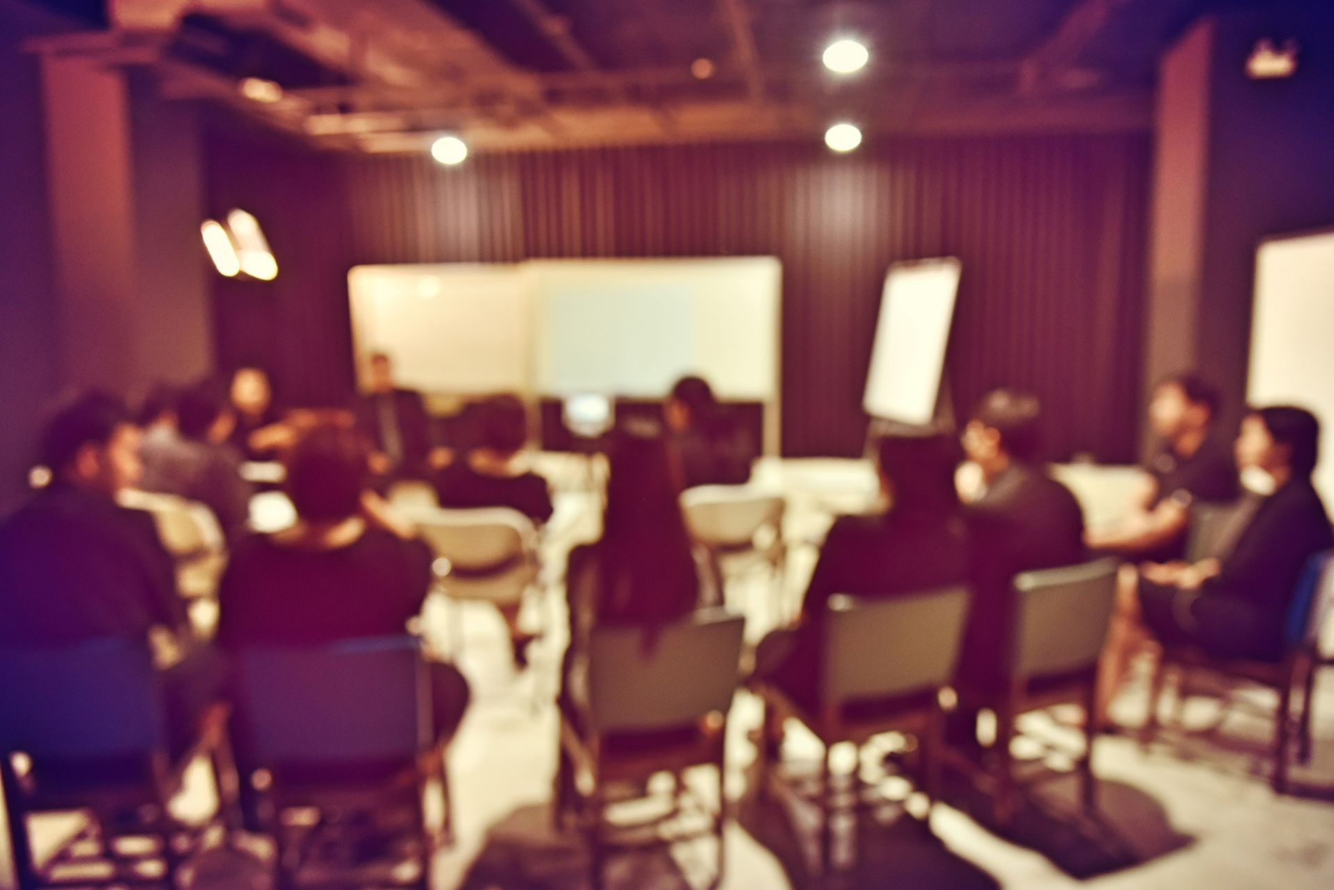 A group of people are sitting in a circle in a room.