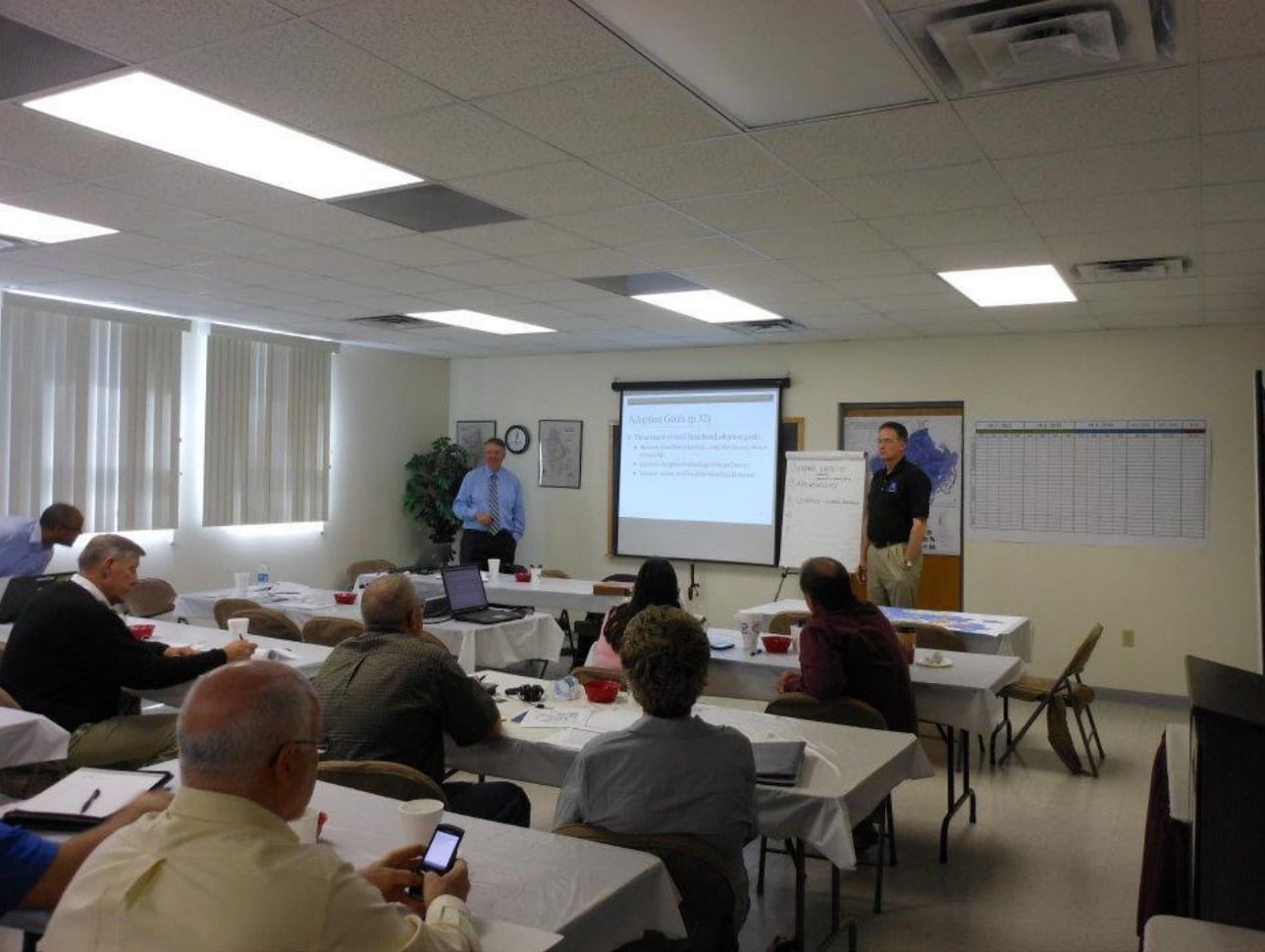 A man is giving a presentation to a group of people