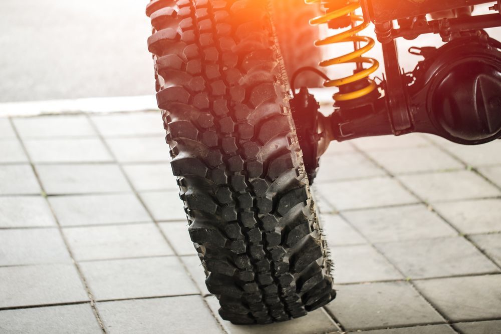 A Close Up Of A Tire And Shock Absorber On A Car — Too Ezy Auto Electrics In Townsville, QLD