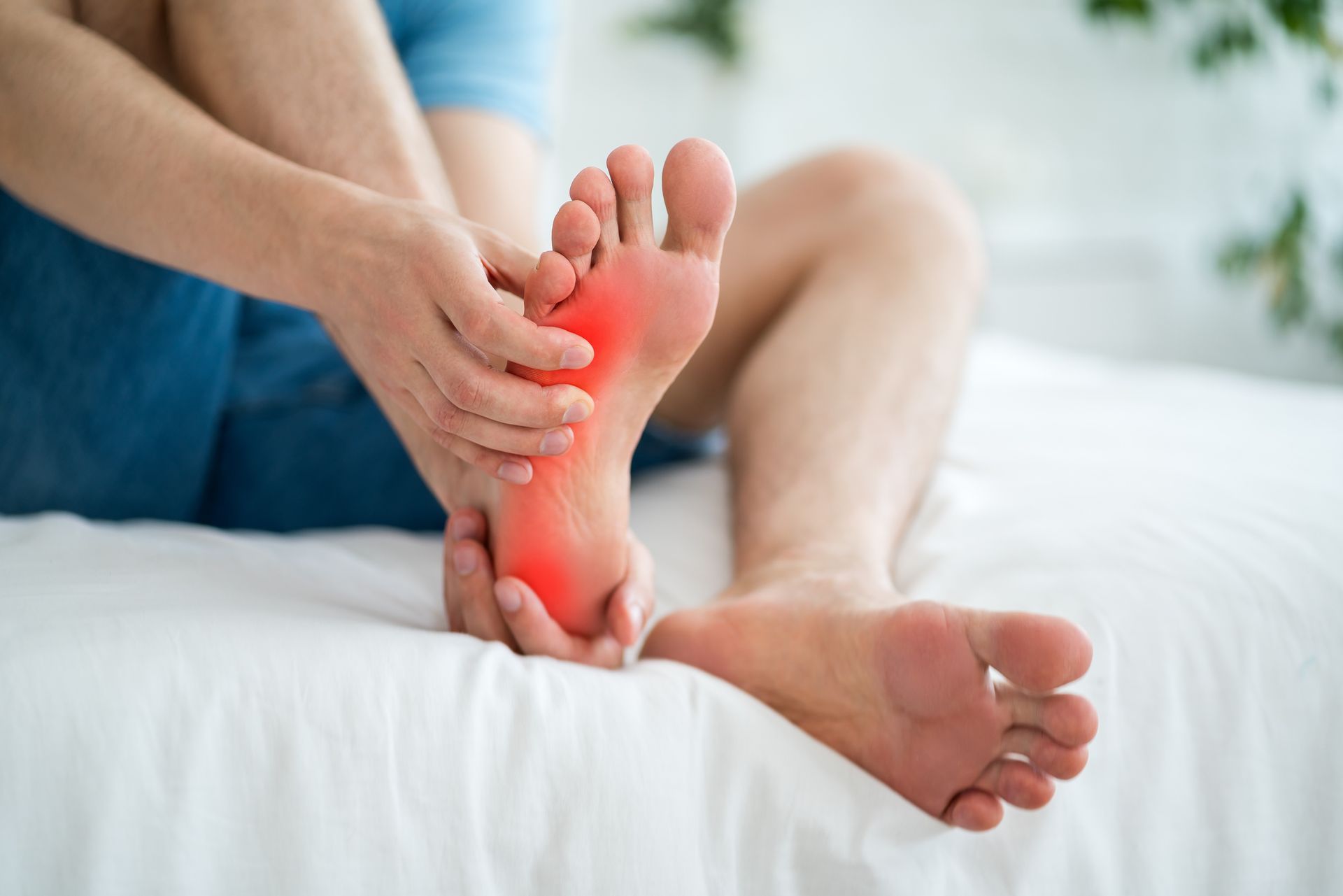 A doctor is examining a patient 's ankle with a blue glove.