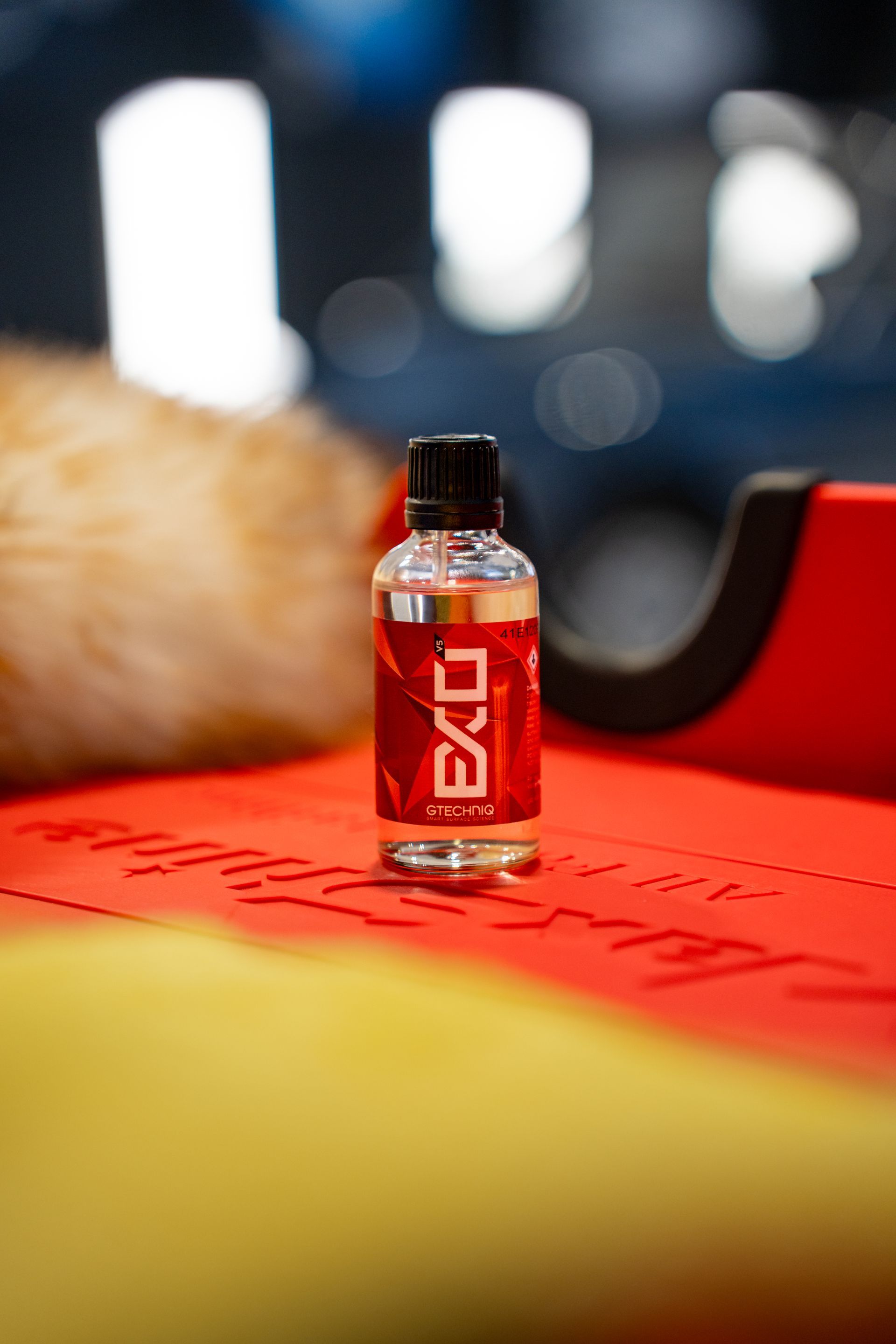 A bottle of exo sitting on top of a red table.