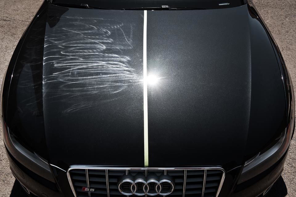 The hood of an audi car is shown before and after being polished