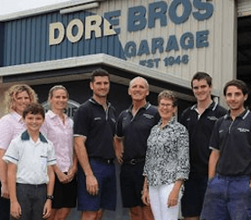 A Group of People Are Posing for a Picture in Front of a Garage — Mechanical Repairs In Gympie, QLD