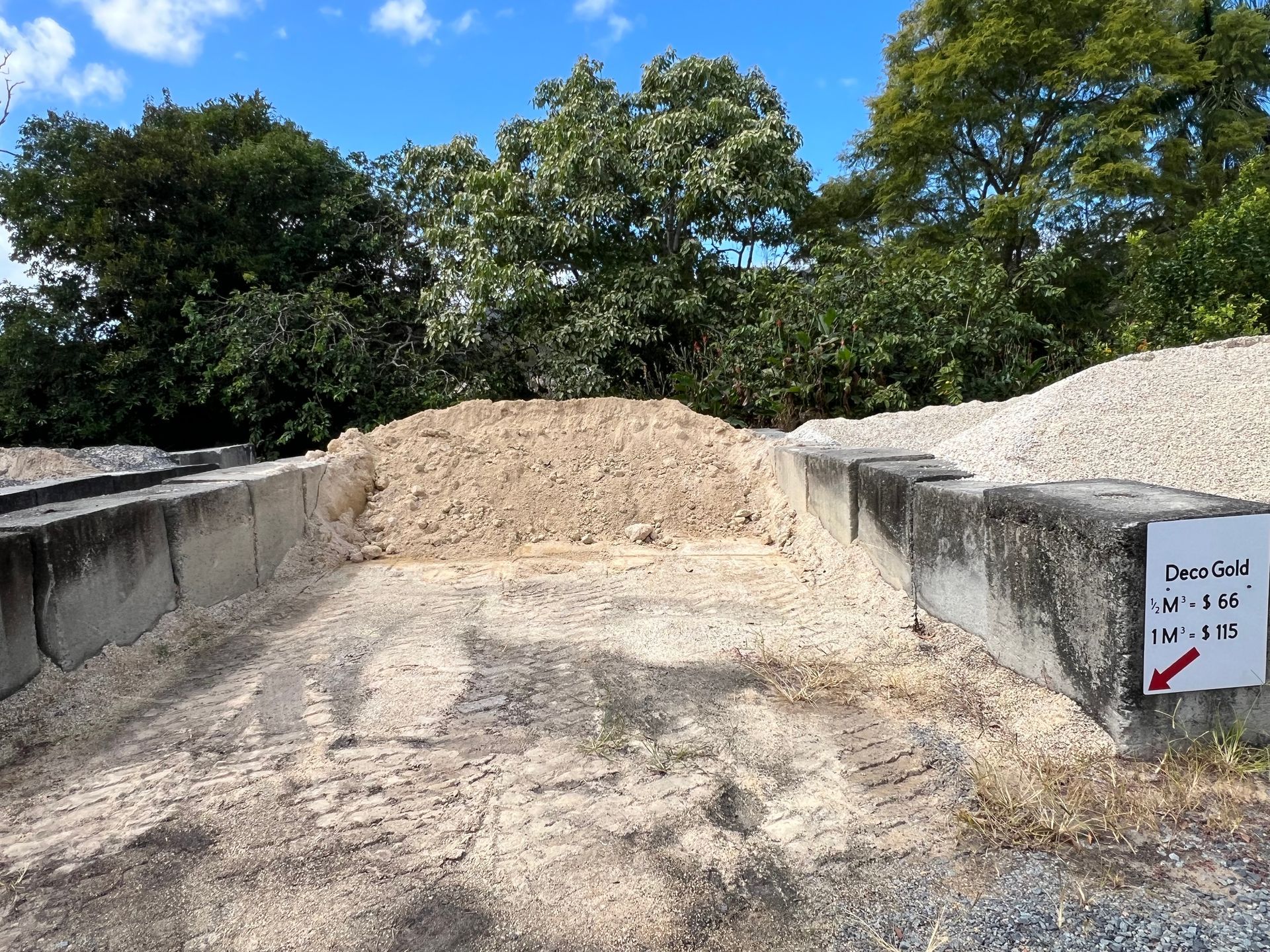 A pile of Deco Gold sand contained by concrete barriers — Laurieton Landscape Supplies In Kew, NSW