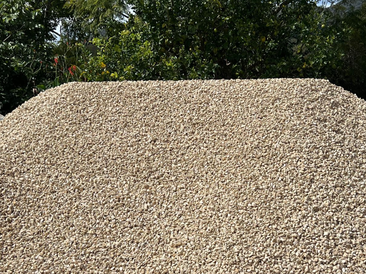 A large, conical pile of light brown gravel or crushed stone — Laurieton Landscape Supplies In Bonny Hills, NSW